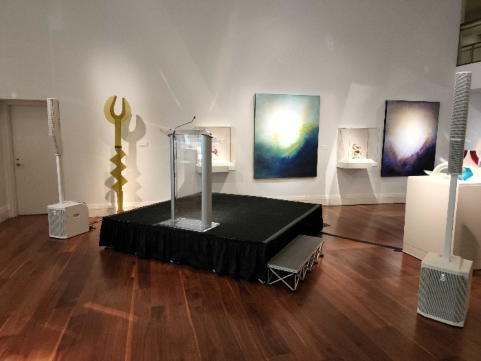 The Gallery in 220 North Tryon, set up by LEMG with a podium and microphone.